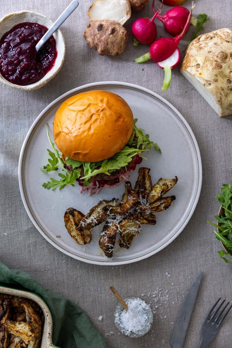 Elgburger med balsamicosyltet løk og selleri- og tyttebærslaw, servert med bakt jordskokk